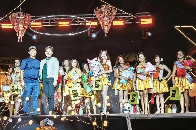 Our team on stage with pageant candidates at a town event